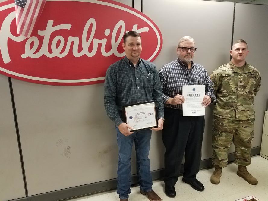On Guard
Peterbilt of Springfield Service Manager Brian Nimmo, left, receives a Patriot Award on April 18 from the Defense Department, recognizing the company’s support of employees and family members who serve in the National Guard and reserves. He was nominated by Army Spc. Mitchel Henry, right, who works as a Peterbilt service technician. Henry says half of Nimmo’s staff members have prior military service or currently are in the reserves. Peterbilt General Manager Skip Wendt, center, also is recognized.